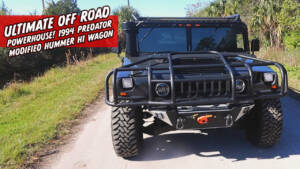 1994 hummer h1 front view with offset snorkel, brush guard, winch system and roof rack with lightbar attachments
