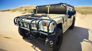 White 1998 Hummer H1 Soft Top with roof rack, brush guard, 12k winch system 6.6 duramax side view